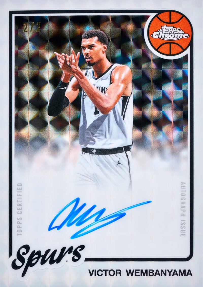 A graded chrome refractor basketball rookie card in a protective slab lit dramatically against dark velvet, representing high-value chase cards