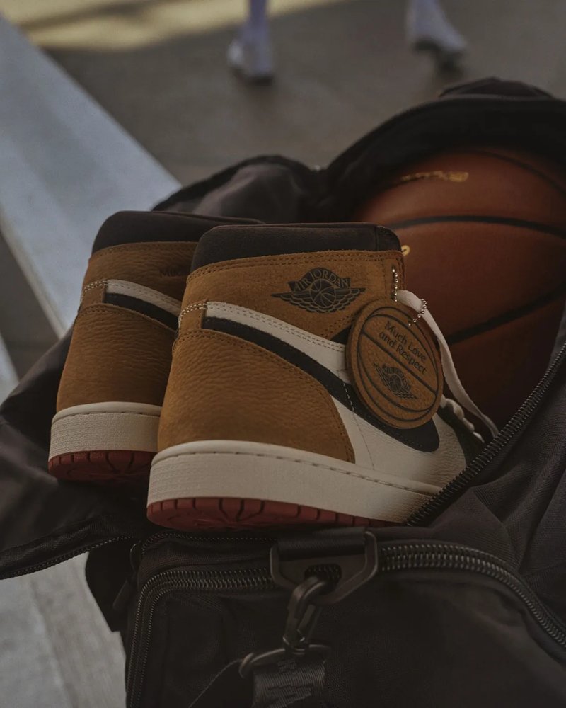 Brown suede high-top sneaker beside a vintage letter on aged paper, representing the MJ retirement letter design narrative