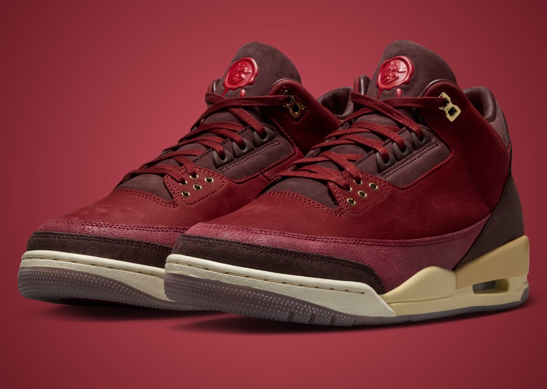 Premium wine-red and cream leather sneaker beside cedar shoe trees and dust bag, representing the Air Jordan 3 BIN 23 limited release packaging