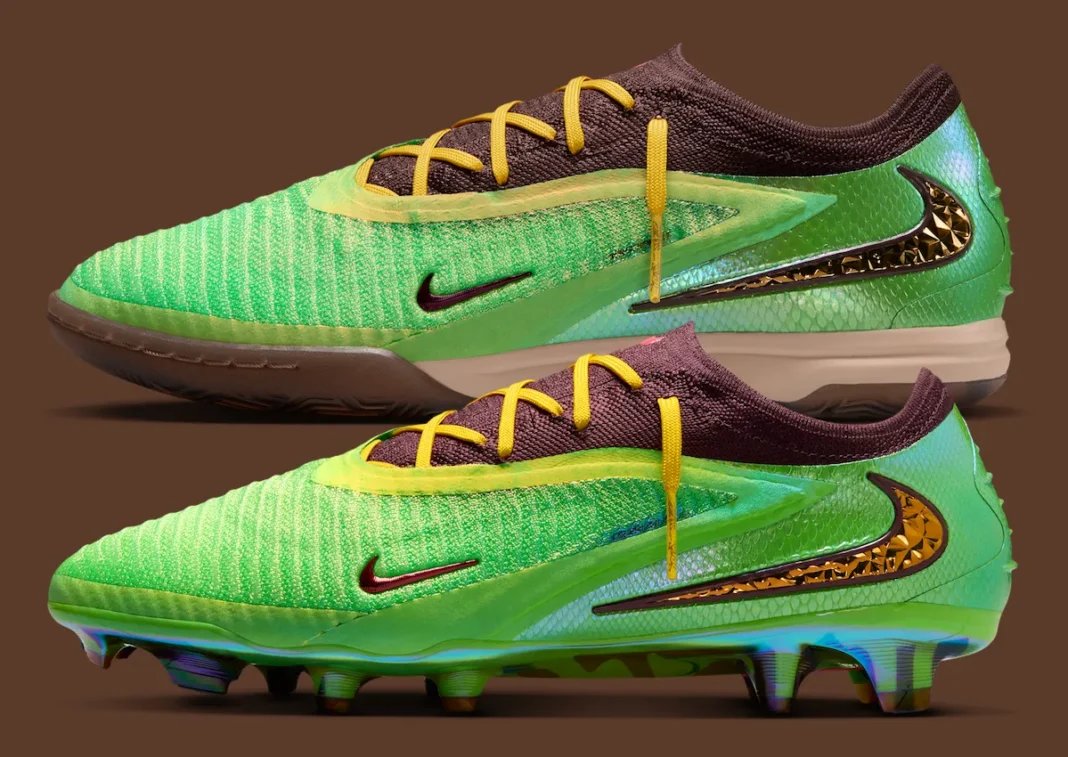 Iridescent multicolour football boots with metallic gold soleplate beside their original box, editorial product photography