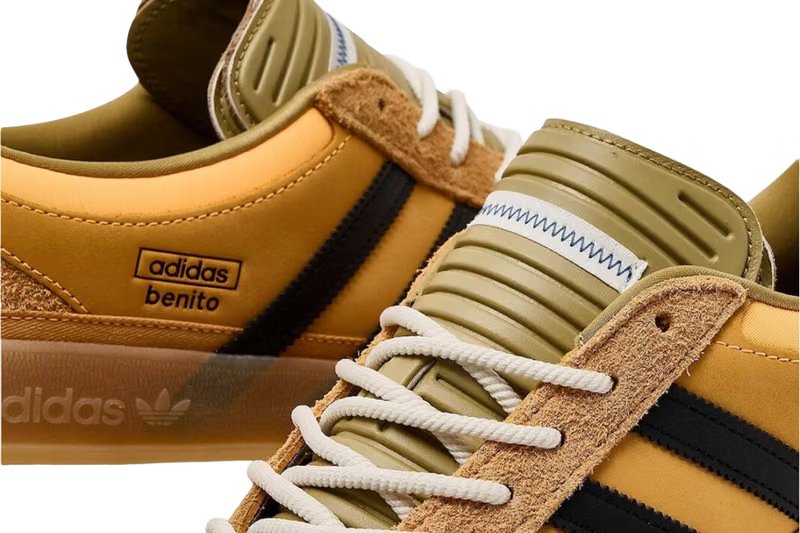 Sealed shipping boxes, padded envelopes, and a customs form on a wooden floor, illustrating the import cost reality for UK sneaker buyers